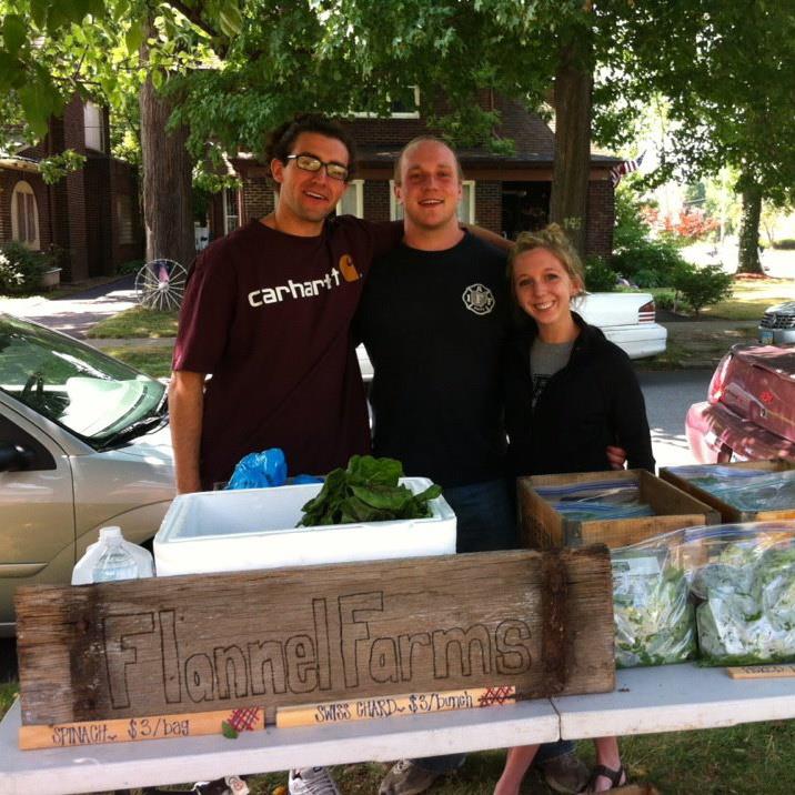 Alex Lipinsky '13 and two other students standing at their capstone project table