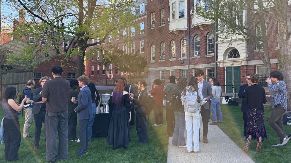 People eating and talking at BBQ event on lawn